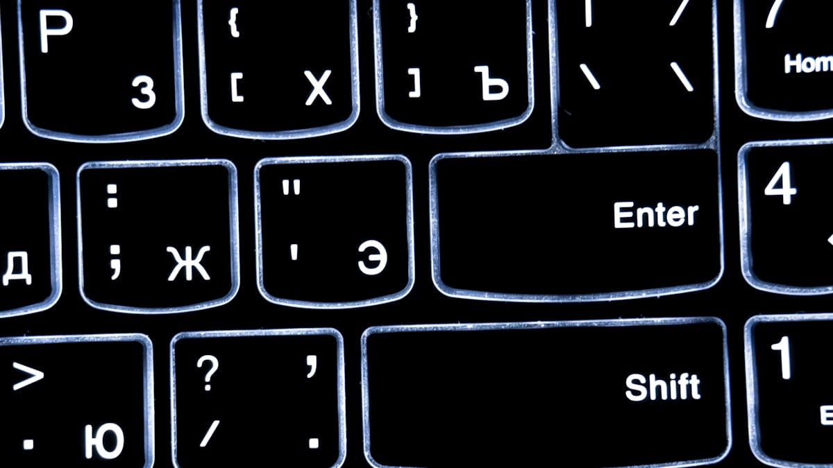 Close-up of a backlit keyboard with cyrillic letters.